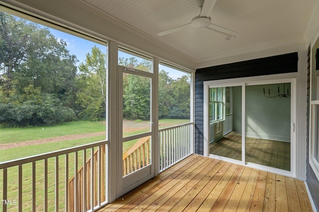 unfurnished sunroom featuring a ceiling fan