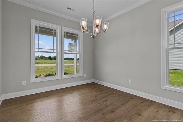 spare room featuring dark wood-style floors, visible vents, crown molding, and baseboards