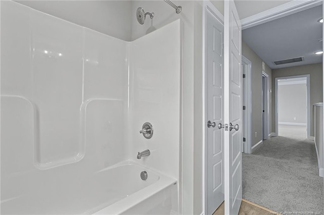 bathroom with shower / tub combination, visible vents, and baseboards