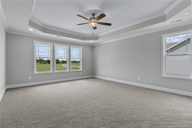 unfurnished room featuring carpet flooring, a raised ceiling, visible vents, and baseboards