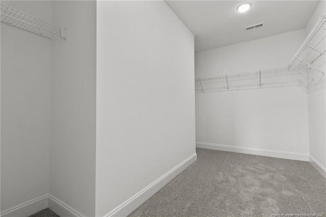 walk in closet featuring carpet flooring and visible vents