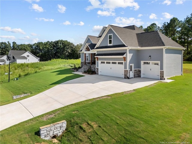 craftsman house featuring a front yard and a garage