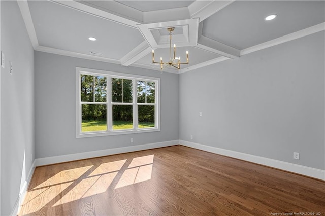 unfurnished room featuring beam ceiling, coffered ceiling, ornamental molding, a notable chandelier, and hardwood / wood-style flooring