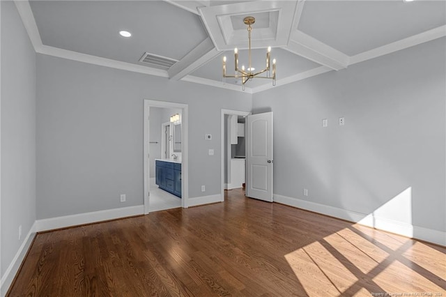 unfurnished bedroom with ensuite bath, ornamental molding, beamed ceiling, a chandelier, and hardwood / wood-style floors