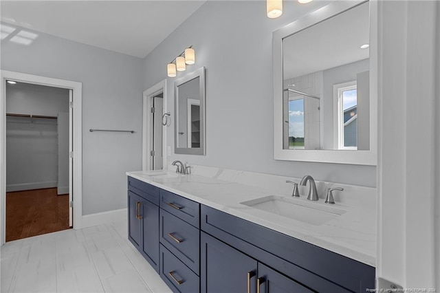 bathroom with vanity and a shower with shower door