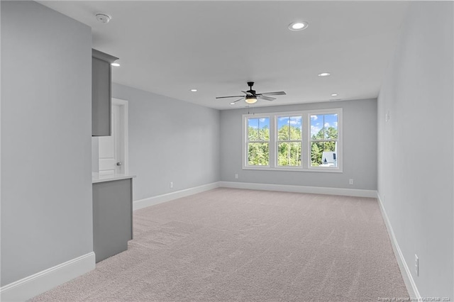 carpeted empty room featuring ceiling fan