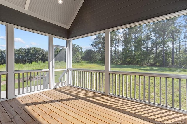 unfurnished sunroom featuring vaulted ceiling