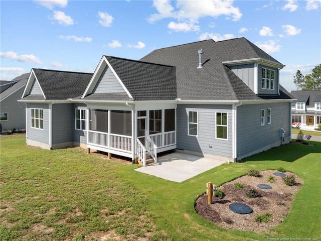 back of house featuring a sunroom, a yard, and a patio