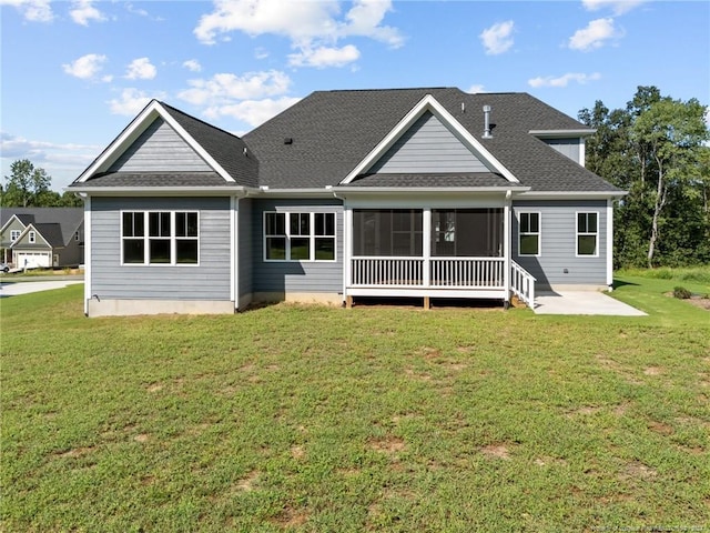 rear view of house featuring a yard and a patio