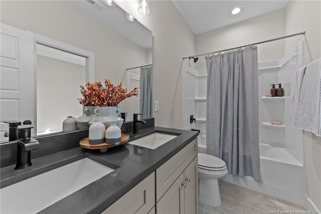 full bathroom featuring tile patterned flooring, vanity, toilet, and shower / bathtub combination with curtain