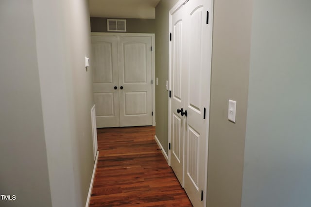 hallway with dark wood-type flooring