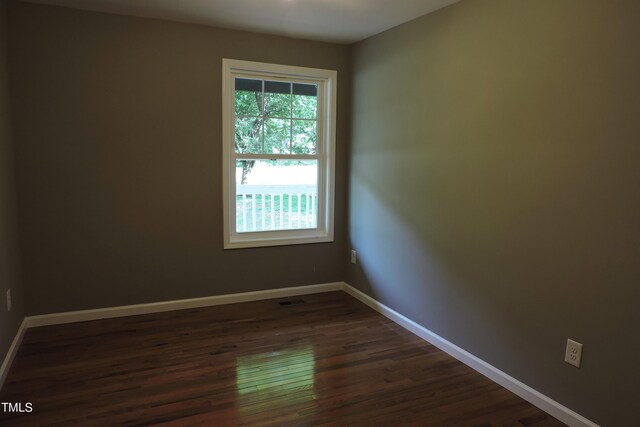 unfurnished room with dark hardwood / wood-style floors