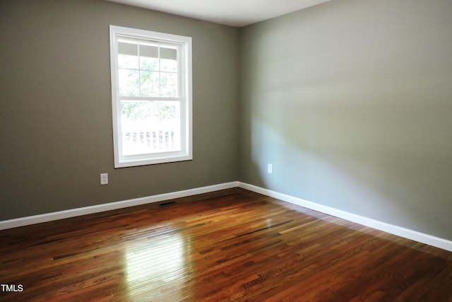 unfurnished room featuring dark wood-type flooring