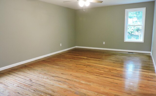 empty room featuring ceiling fan and light hardwood / wood-style flooring