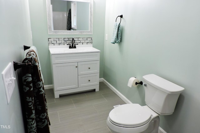 bathroom with vanity, decorative backsplash, toilet, and tile patterned floors