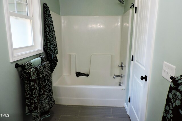 bathroom featuring shower / washtub combination and tile patterned flooring