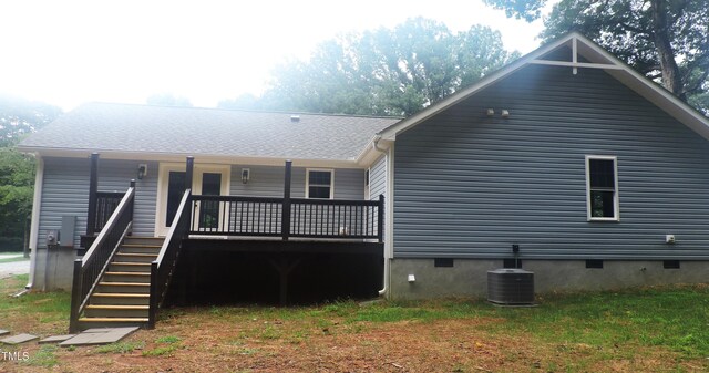 rear view of property with central AC