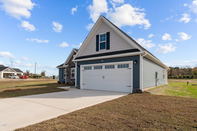 exterior space featuring a lawn and a garage