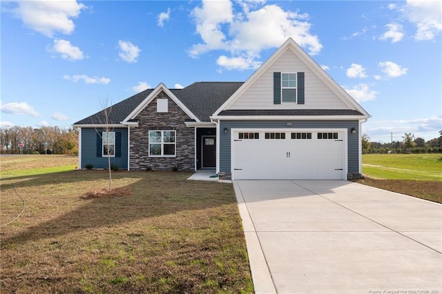 craftsman inspired home with a garage and a front lawn