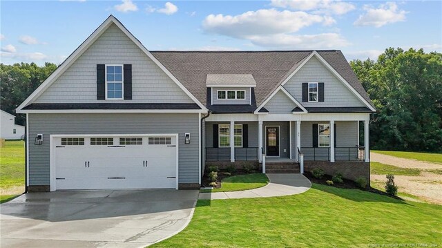 craftsman-style house featuring covered porch and a front yard