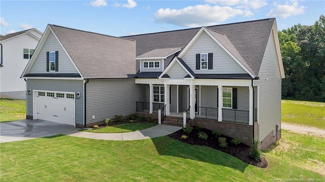 view of front of house with a porch, a garage, and a front yard