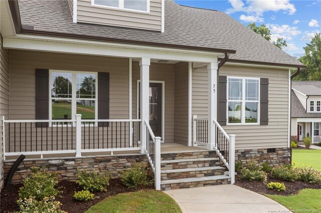 view of exterior entry featuring a porch