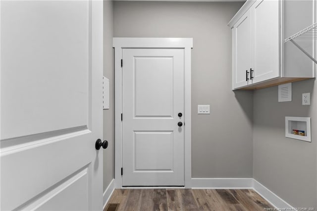 laundry room featuring washer hookup, wood finished floors, visible vents, baseboards, and cabinet space