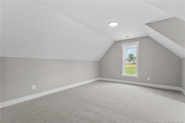 bonus room with carpet, lofted ceiling, and baseboards