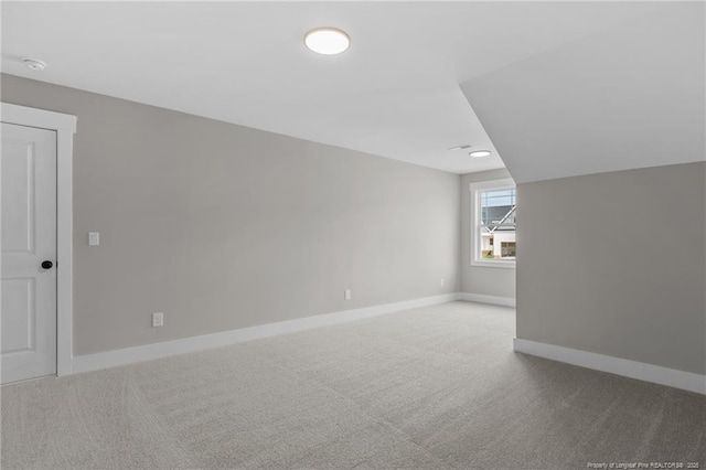 bonus room with carpet and baseboards