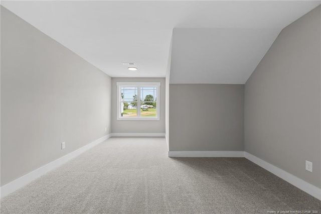 bonus room featuring carpet floors, visible vents, and baseboards