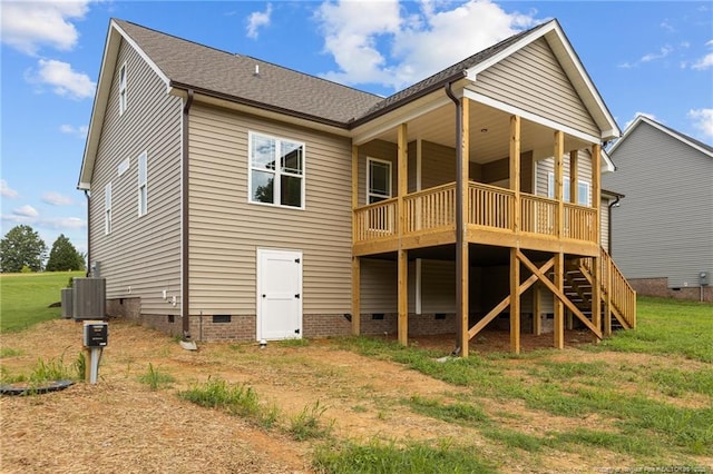 back of property featuring a deck, central AC, a shingled roof, a yard, and crawl space