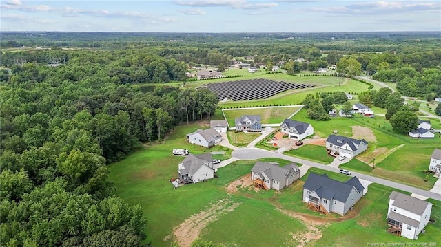 bird's eye view featuring a forest view and a residential view