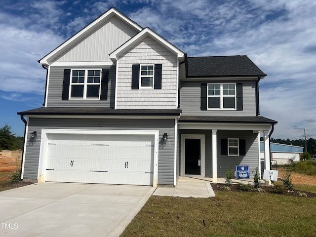 view of front of house featuring a garage and a front lawn