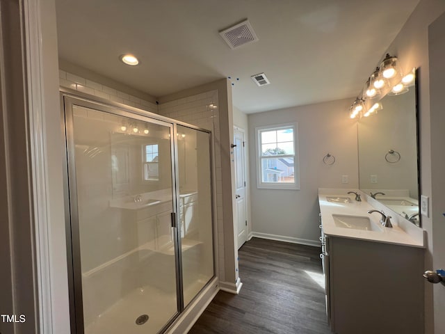 bathroom with vanity, wood-type flooring, and a shower with shower door