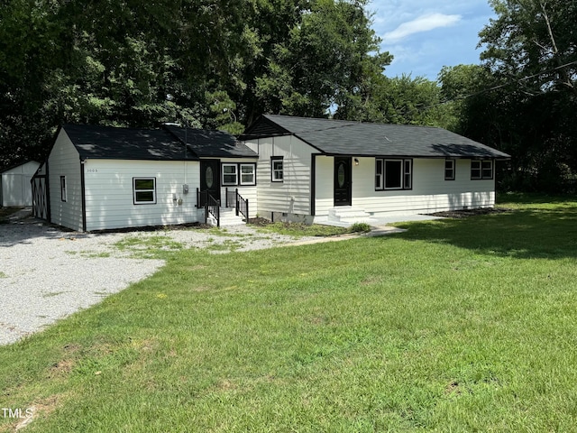 view of front of property with a shed and a front yard