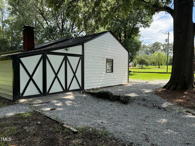 view of outdoor structure featuring a lawn