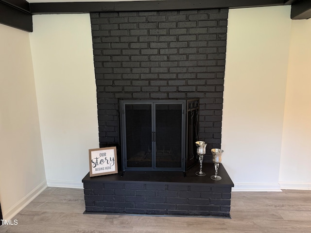 details with hardwood / wood-style flooring and a fireplace