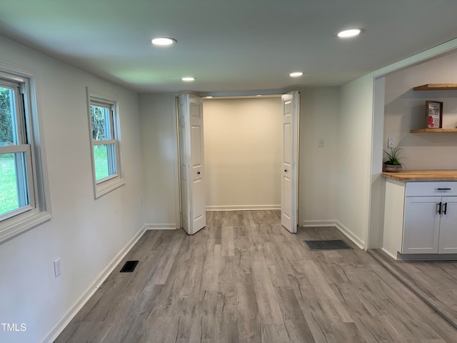 laundry room featuring light wood-type flooring