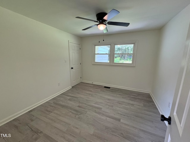 spare room featuring light hardwood / wood-style flooring and ceiling fan