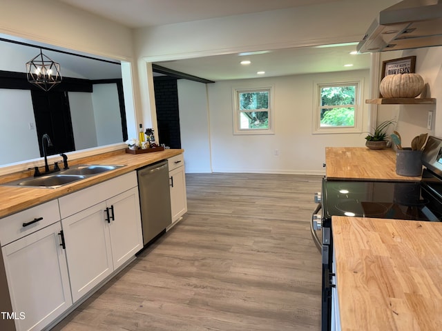 kitchen featuring white cabinetry, butcher block countertops, dishwasher, stove, and sink