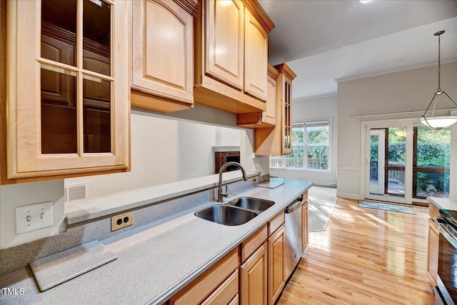 kitchen featuring light hardwood / wood-style flooring, hanging light fixtures, sink, dishwasher, and ornamental molding