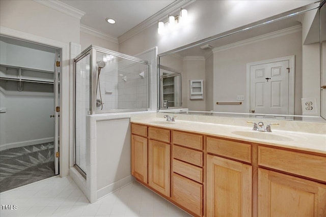 bathroom featuring ornamental molding, tile patterned floors, a shower with shower door, and vanity