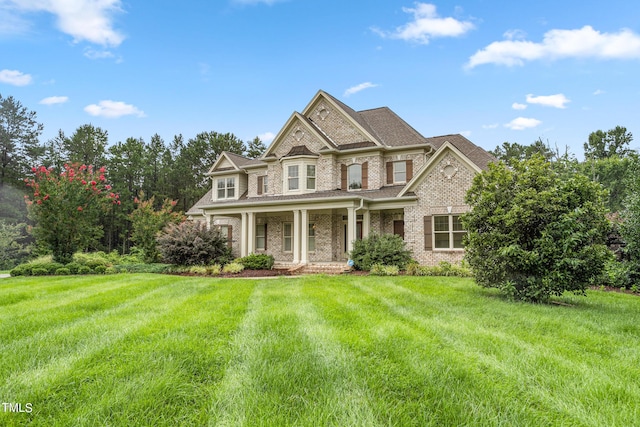 view of front of home with covered porch and a front yard