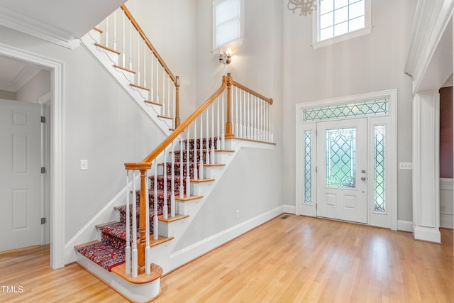 entryway featuring wood-type flooring and crown molding