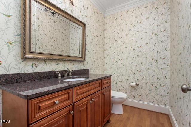 bathroom with hardwood / wood-style floors, toilet, vanity, and ornamental molding