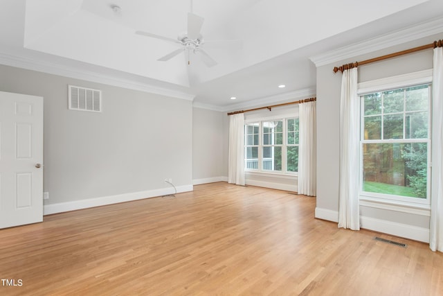 unfurnished room featuring ceiling fan, a raised ceiling, crown molding, and light hardwood / wood-style floors