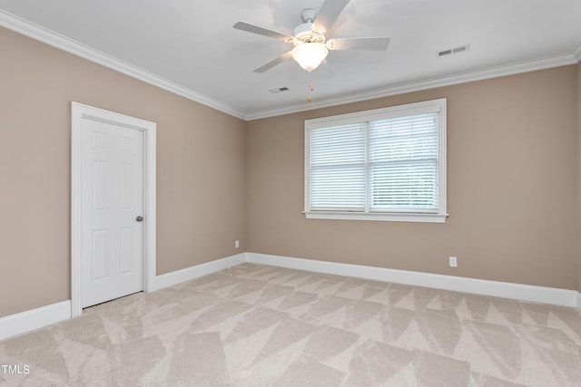 carpeted spare room featuring ceiling fan and ornamental molding