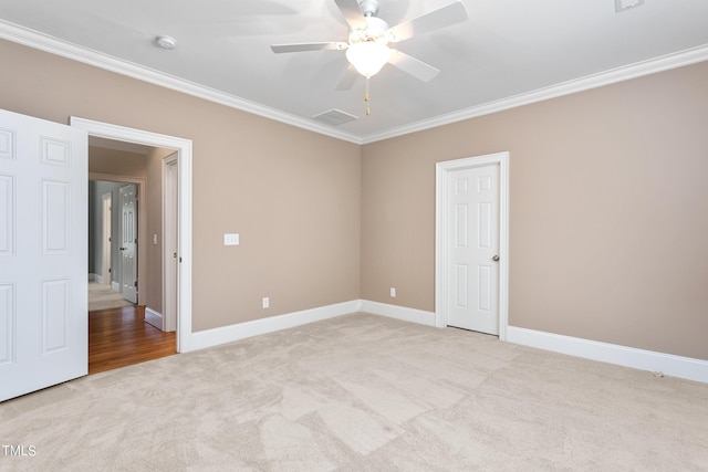 unfurnished room featuring crown molding, ceiling fan, and light carpet