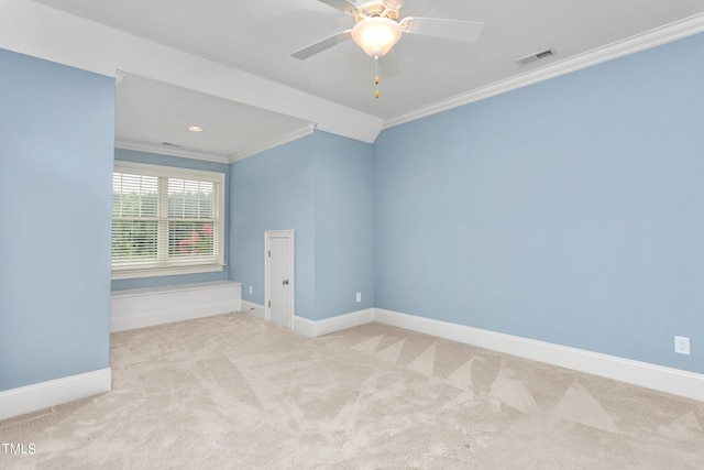 unfurnished room with ceiling fan, ornamental molding, and light carpet