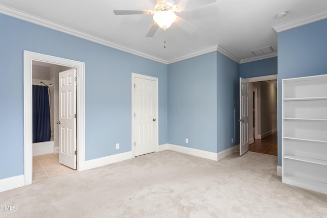 unfurnished bedroom with ensuite bath, a closet, ornamental molding, ceiling fan, and light colored carpet